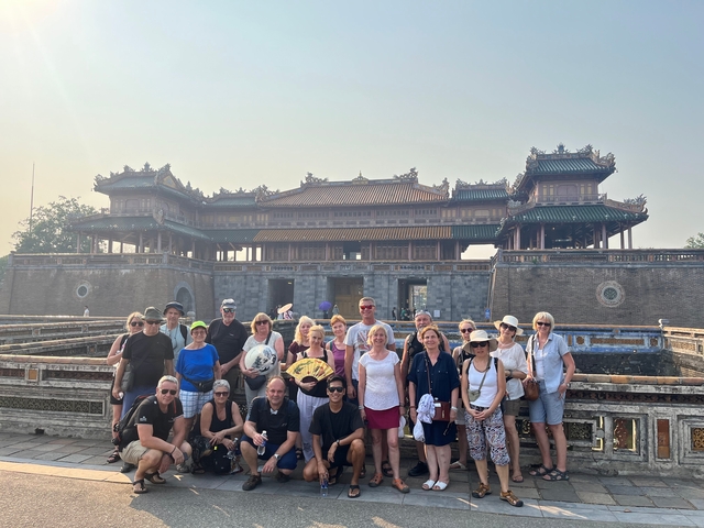 Large group of people in front of a historic building.