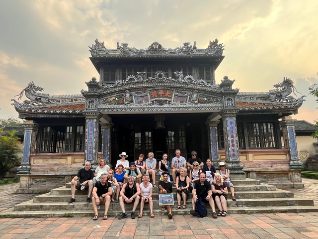Large group of people in front of a traditional building.