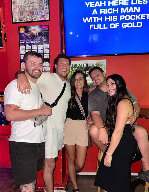 Group of friends posing in a bar setting.