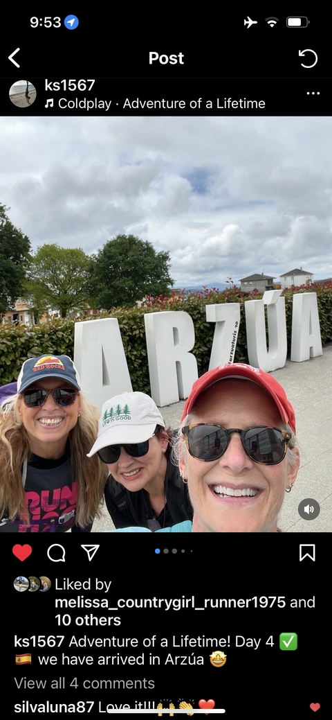 People posing with large 'Arzua' letters in a park setting.