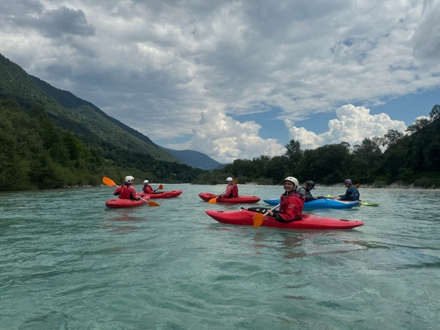       Group kayaking in a scenic river.
  