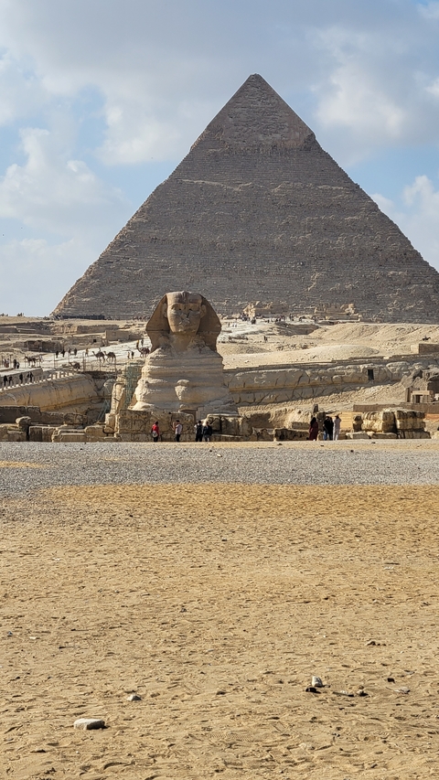 The Great Sphinx of Giza with a few visitors nearby.