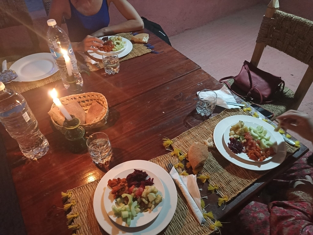 A cozy dining table set with plates of food and a candle.