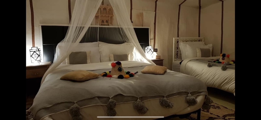 Hotel room with neatly made beds and soft lighting.