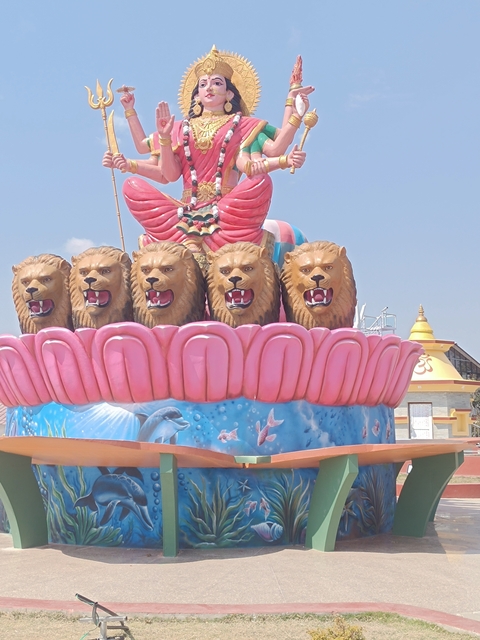 Colorful statue with lion heads and decorative base.
