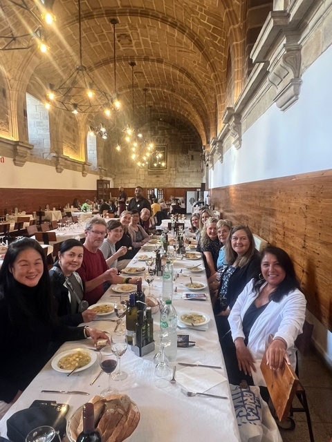 Group dining in a cozy restaurant with ornate lighting.