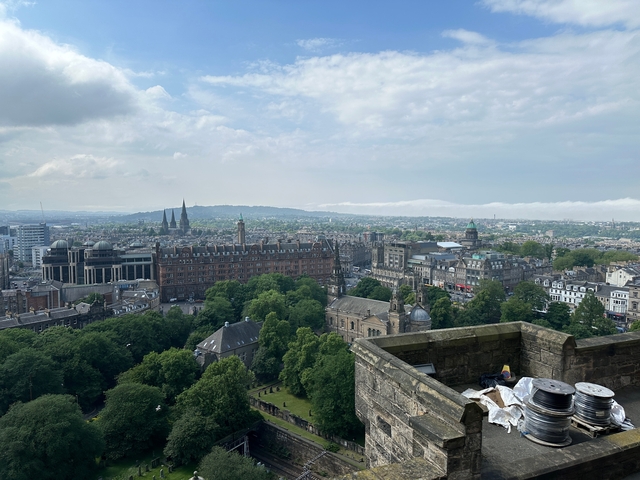 Panoramic view of a city skyline with historical spires and buildings.
