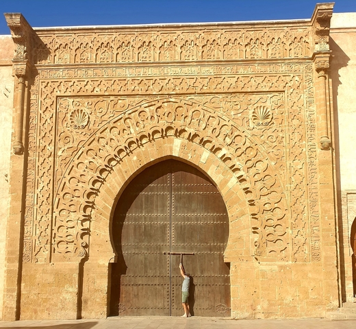       Intricately carved large stone doorway with decorative arches.
  
