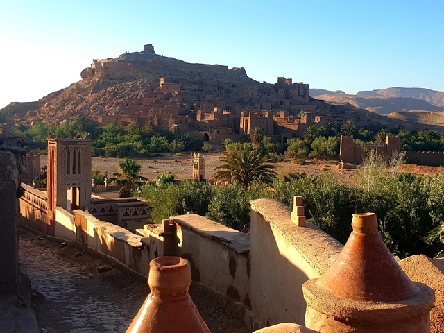       Ancient clay town with arches and greenery.
  