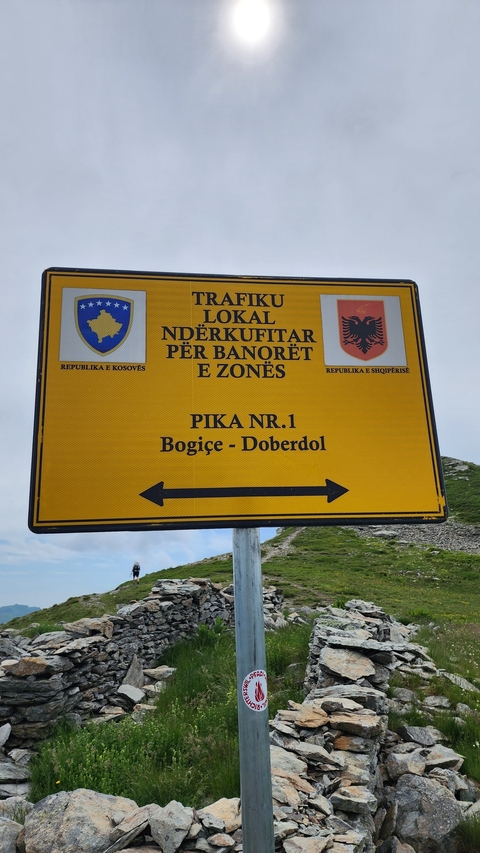 Directional sign indicating a local border crossing in Albania.