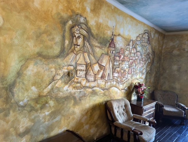       Mural depicting a historical scene and landscape.
  