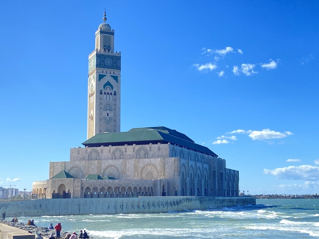 Hassan II Mosque under blue skies.