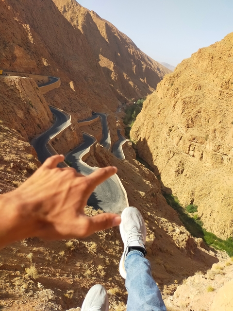       Twisting mountain road with dramatic cliffs.
  