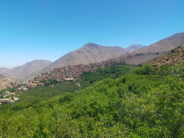       Lush valleys below rugged mountains.
  