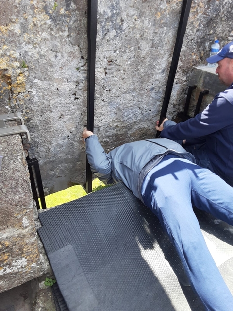 Person kissing the Blarney Stone.