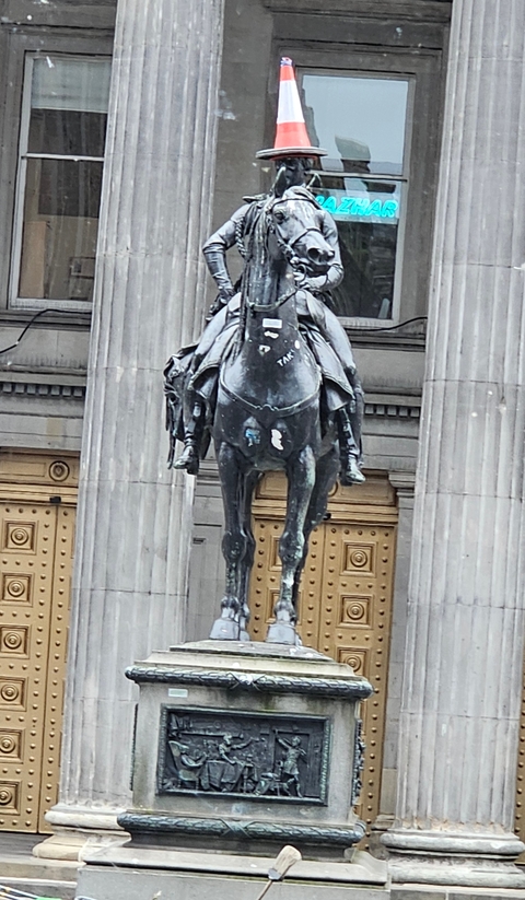 Statue of a person on horseback in a city.