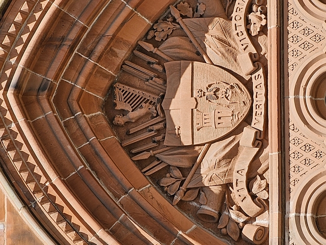       Close-up of a decorative emblem on a building.
  