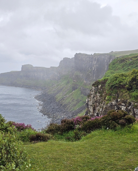       Coastal cliffs in a rugged landscape.
  