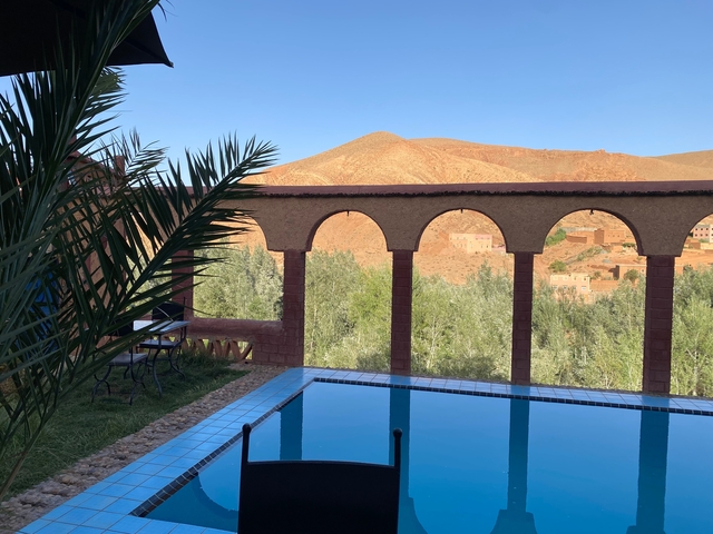       Scenic view of desert architecture with a pool.
  
