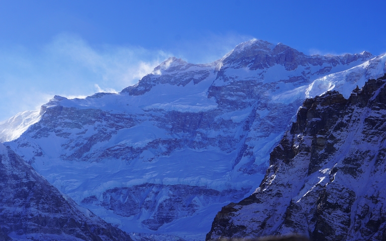       Snow-covered mountain under a clear sky.
  