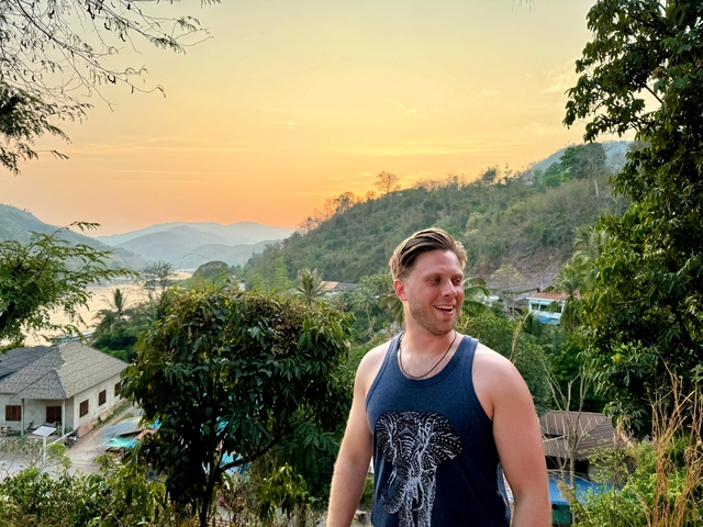 Traveler with sunset view over a river or lake.