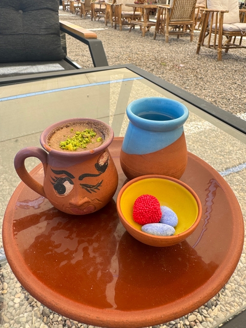 Ceramic cups with snacks on a table.