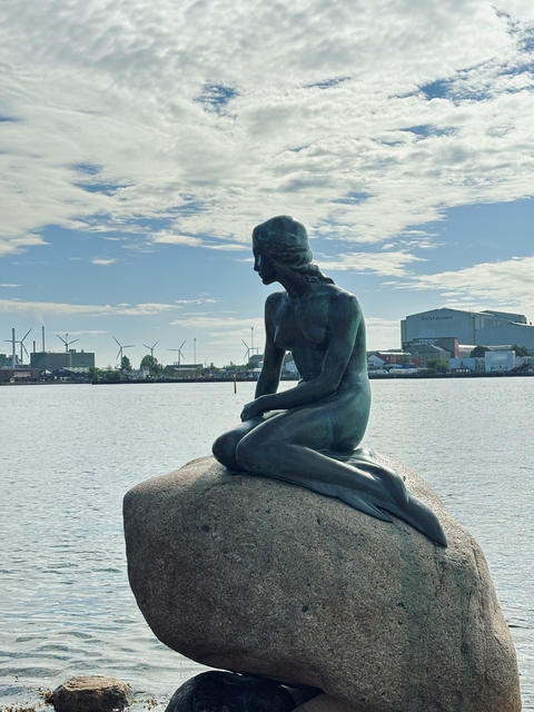       Statue of The Little Mermaid by the water.
  