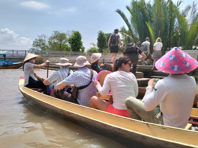 People in a boat under the sun.