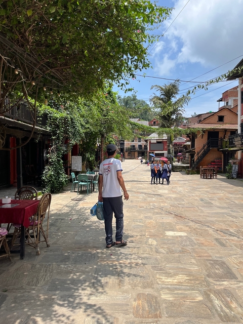       Pedestrian street with people and shops in a town.
  