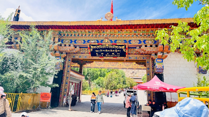 Entrance gate to Sera Monastery with colorful decorations.
