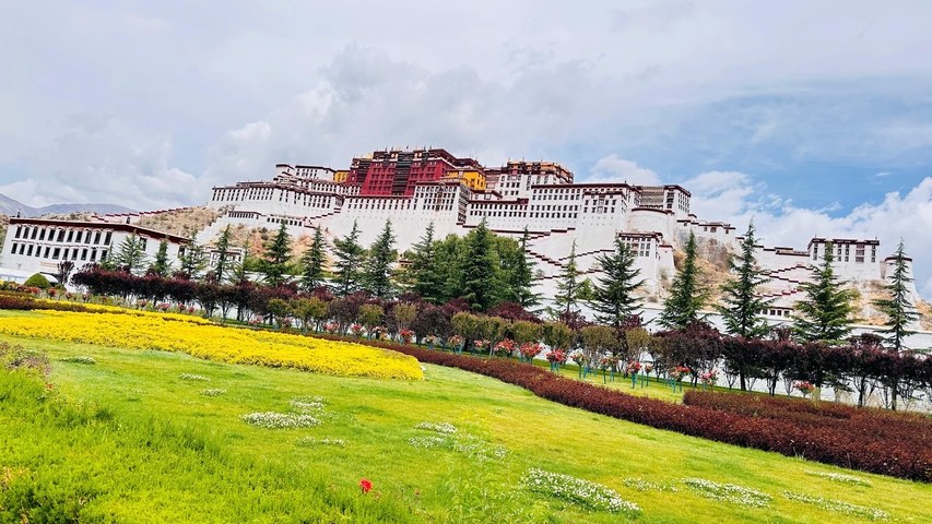 The Potala Palace with colorful blooms in Lhasa.