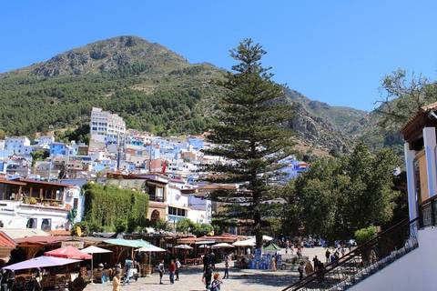 Chefchaouen with colorful buildings nestled against a hill.