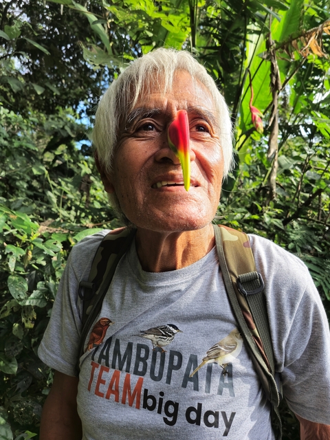 Close-up of a person with a colorful flower on the face.