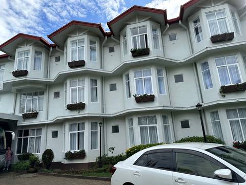       Hotel with unique architecture and flower boxes.
  