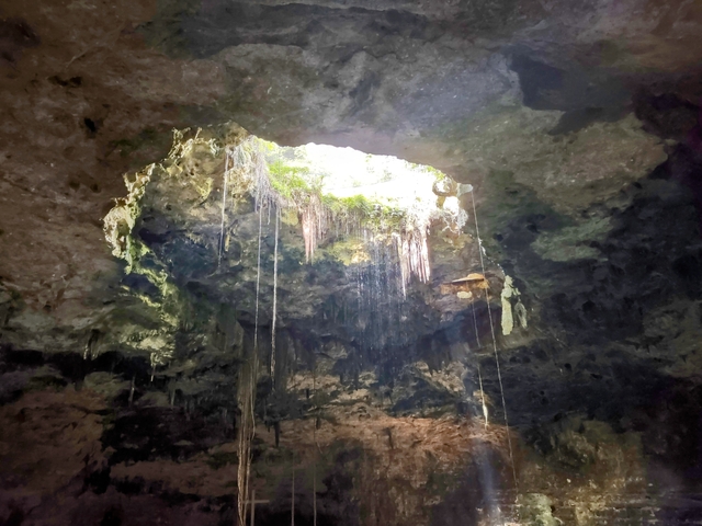       Cave interior with light streaming from an opening.
  