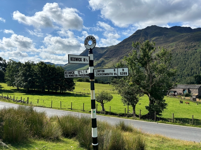 Vintage signpost with directions to nearby places.