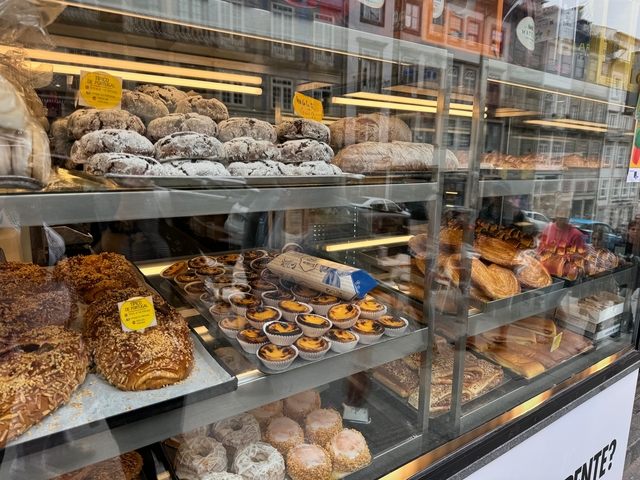       A variety of pastries displayed in a bakery window.
  