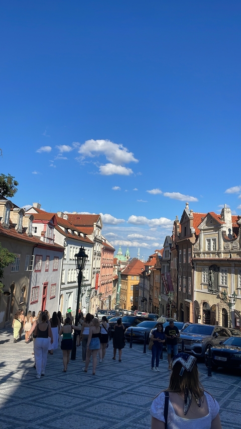 View of colorful buildings under a blue sky with clouds.