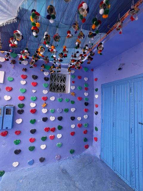 Wall with colorful heart decorations on a bright blue surface.