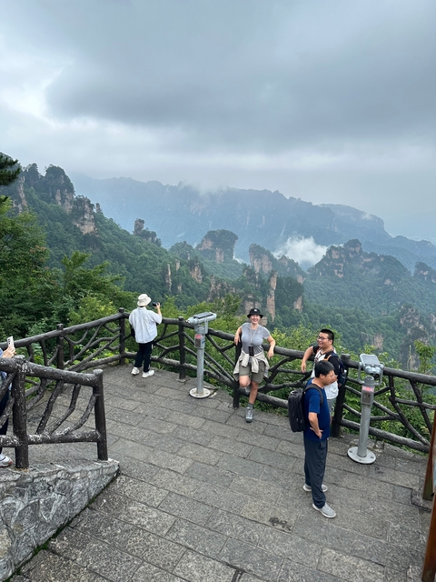 People enjoying a scenic view from a mountain viewpoint.