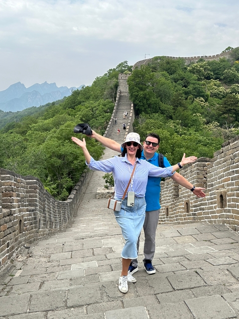 Couple posing on the Great Wall of China.