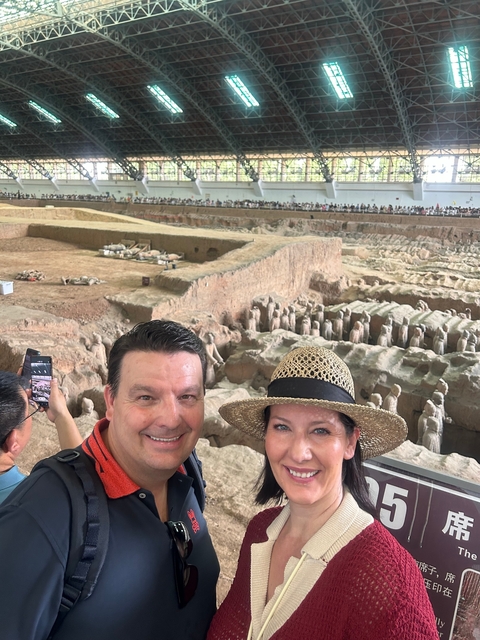 Couple in front of the Terracotta Army excavation site.
