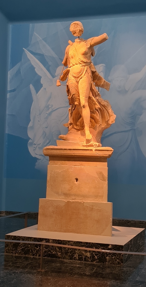       Ancient stone statue with blue background
  