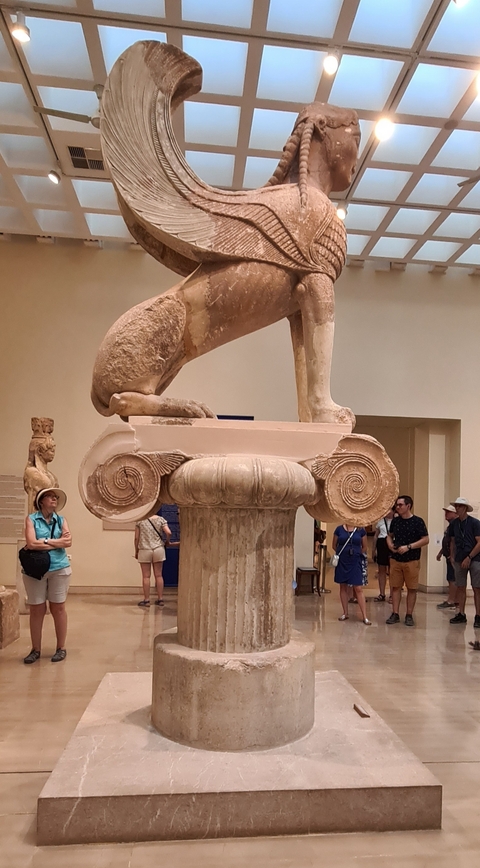 Ancient sculpture with people observing