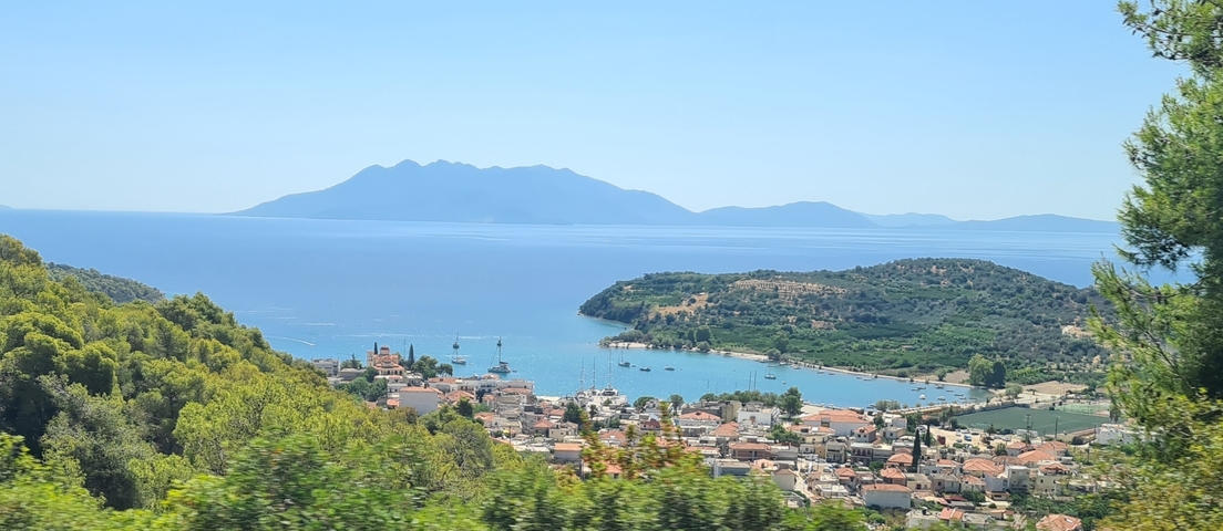       Coastal town with mountains in the background
  
