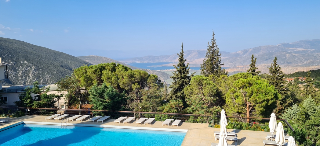 Swimming pool with scenic view of mountains and sea