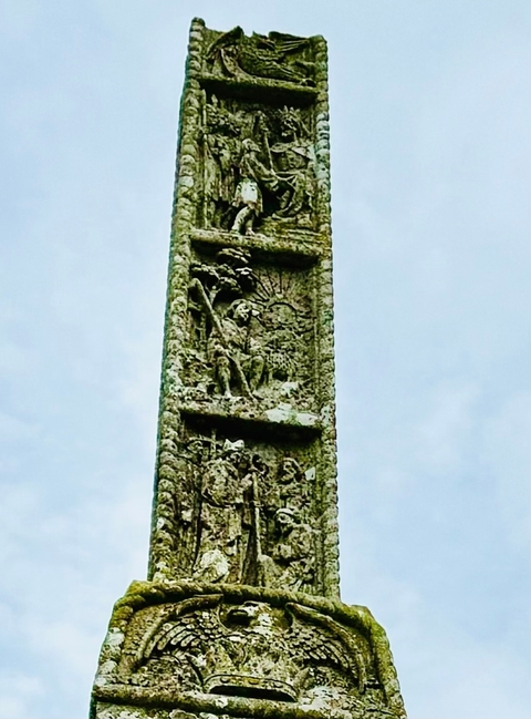       Ancient stone cross with detailed carvings.
  