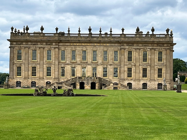       A grand stately home with expansive lawns.
  