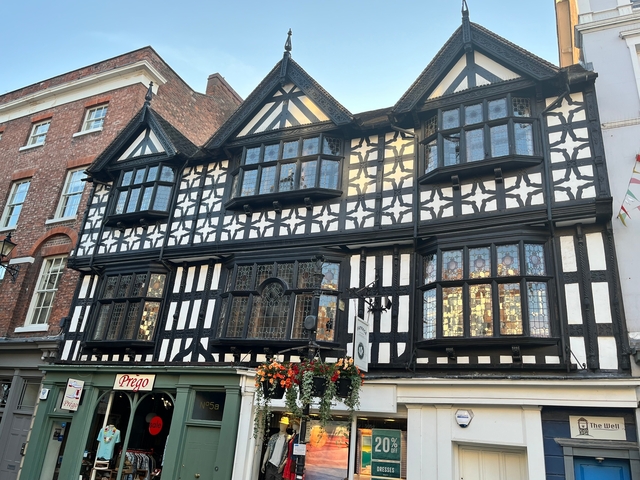 Tudor-style building with hanging flowers.