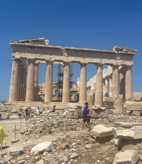 The Parthenon with scaffolding and tourists around.